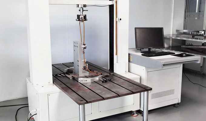 Vertical impact test rig striking a carbon rim